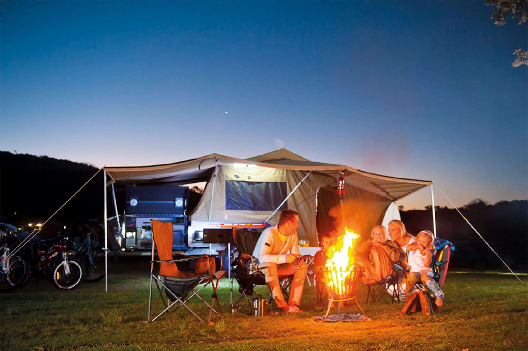 family campfire and camper trailer