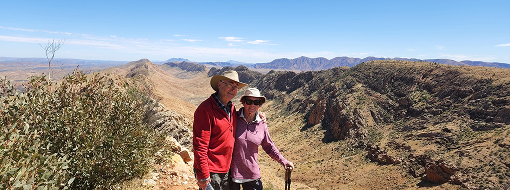 "Red Centre Australia: Counts Point Larapinta Trail" - Hikers trekking through scenic Australian outback on Larapinta Trail.