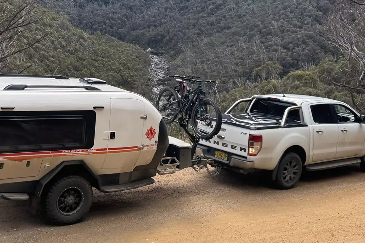Kube Teardrop Camper with iSi Bicycle Rack Teardrop camper with iSi bicycle rack attached, parked outdoors with scenic Australian background.