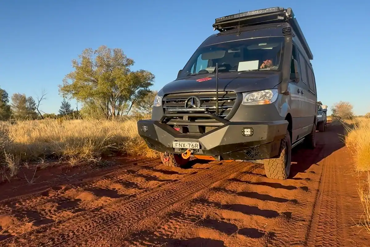Kimberley Kampers Offroad Motorhome on Corrugated Dirt Road in Australian Desert Kimberley Kampers offroad motorhome driving on a heavily corrugated red dirt road in the Australian outback desert, showcasing its heavy-duty suspension and off-road capability.